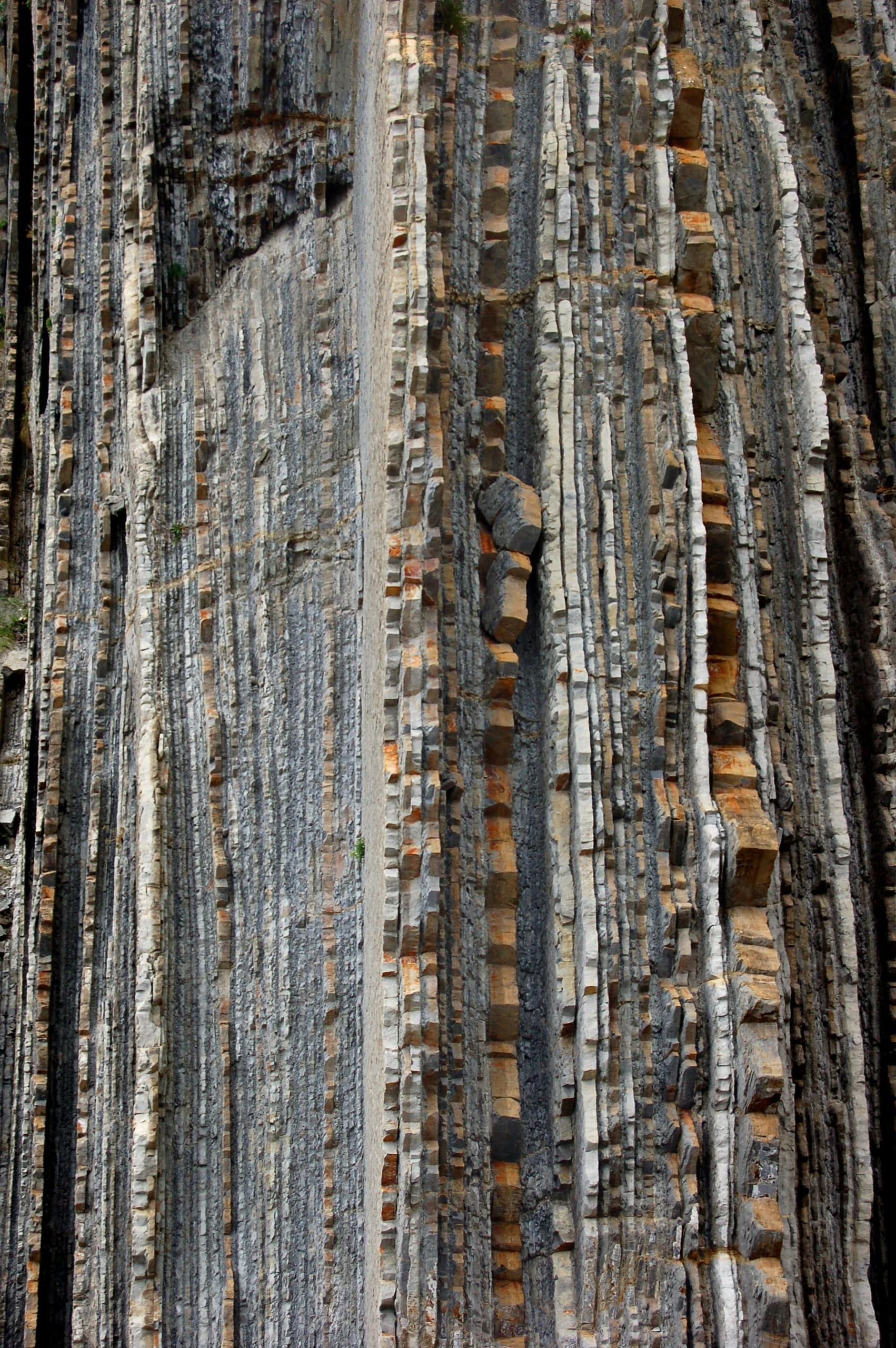 Near-vertical layers of limestone and marl in the foreground, Zumaia flysch